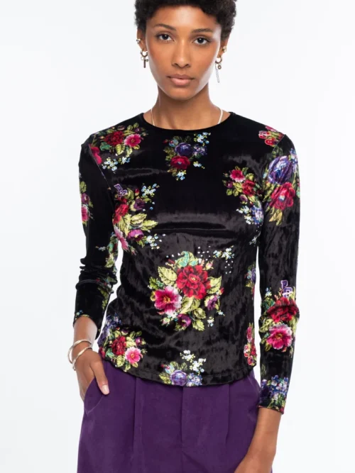 Το Bouquet Top ξεχωρίζει για το εντυπωσιακό all-over floral print με ψηφιακά λουλούδια εμπνευσμένα από την τεχνική του cross stitch, πάνω σε μαύρο ice velvet με ιδιαίτερη ανάγλυφη υφή.